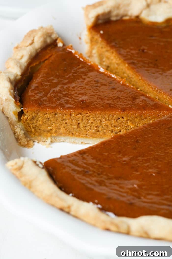 A perfectly baked, healthy pumpkin pie, golden crust with a smooth filling, ready to be enjoyed.