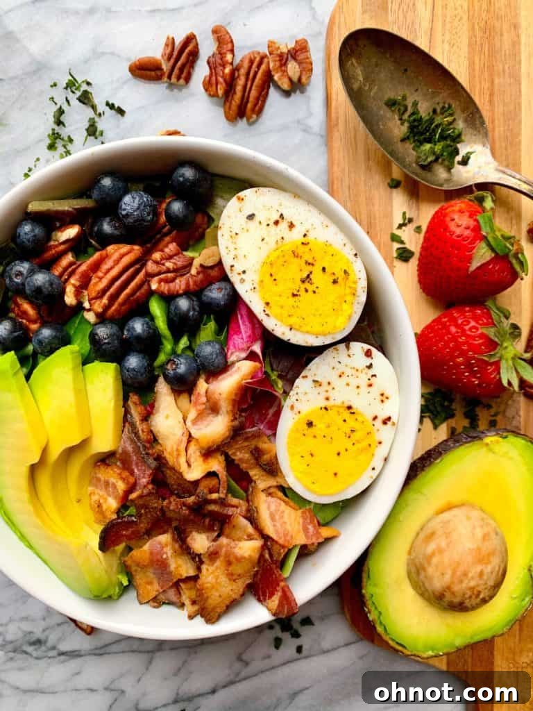 Fresh Cobb salad with a twist, featuring blueberries and pecans, ideal for a light summer lunch or side dish.