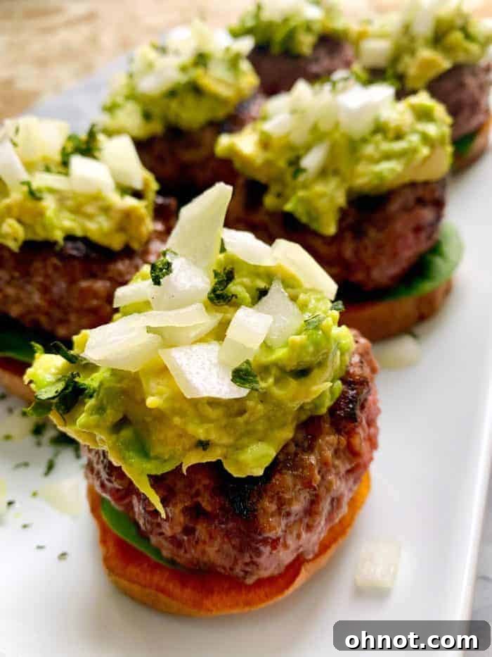Mini grilled hamburger sliders served on sweet potato buns, perfect for a party appetizer or light main course.