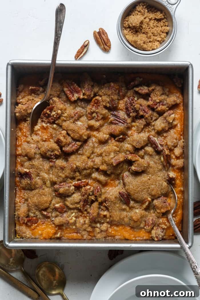 A close-up shot of the baked gluten-free sweet potato casserole with a beautiful golden pecan topping.