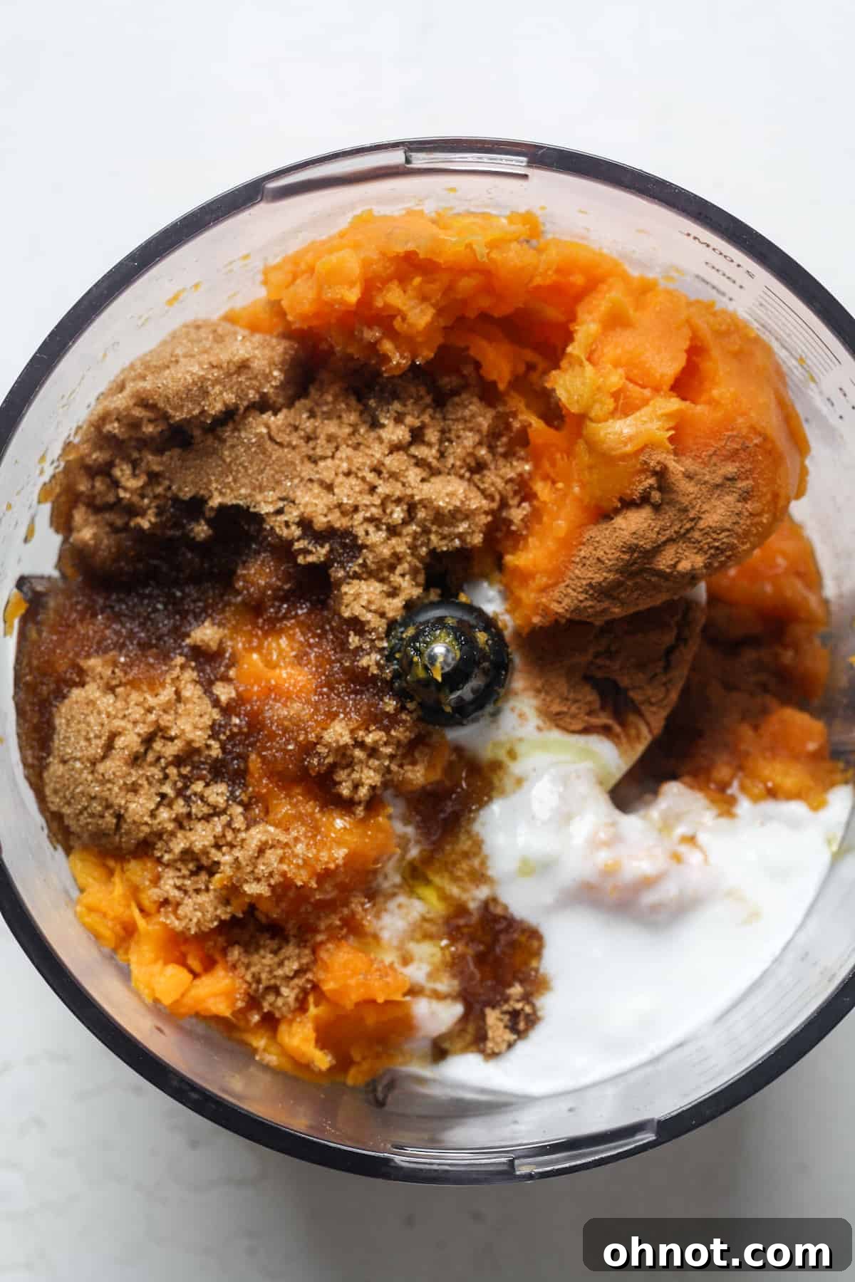 Sweet potatoes, brown sugar, and other filling ingredients in a food processor.