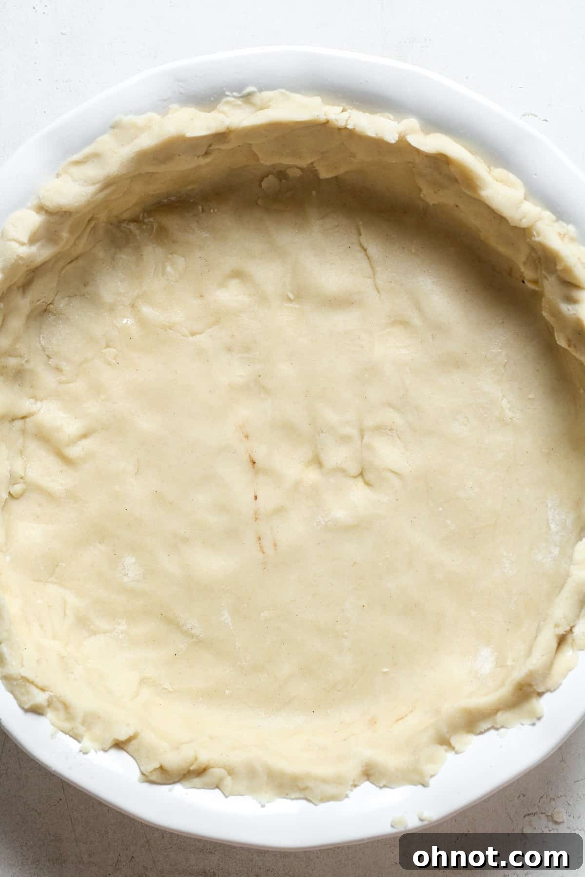 Unbaked gluten-free pie crust neatly fitted into a pie plate.