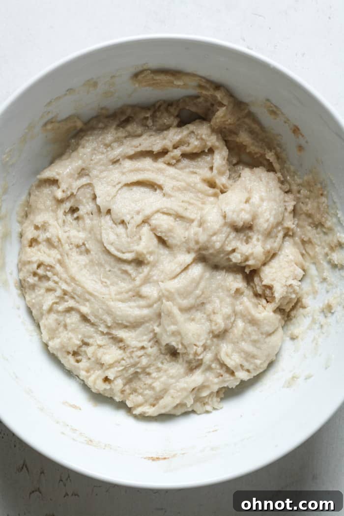 Donut batter in bowl after mixing, showcasing a thick consistency ready for baking.
