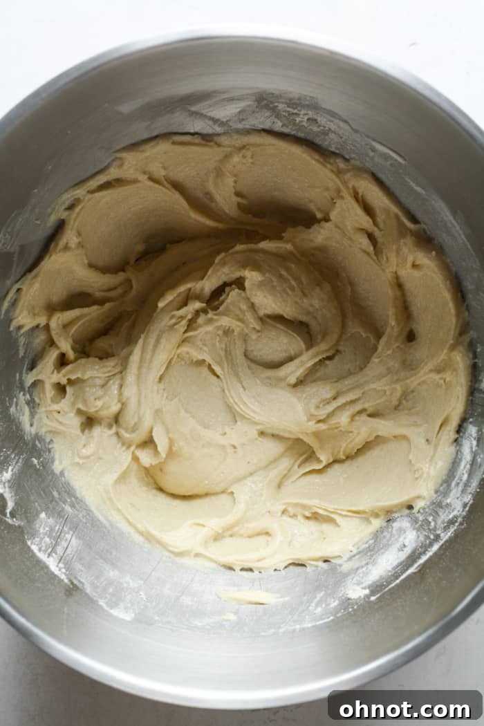 Thick gluten-free muffin batter in a bowl after dry ingredients have been mixed in, showing a consistent texture.