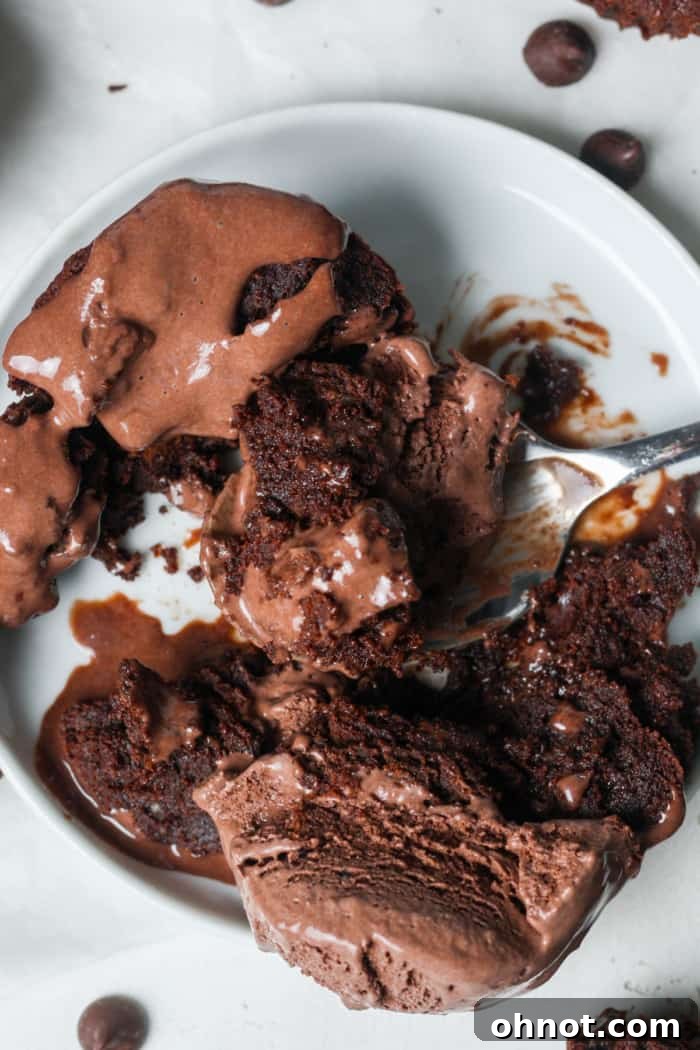 A delicious brownie bite ice cream sundae, topped with hot fudge and whipped cream.
