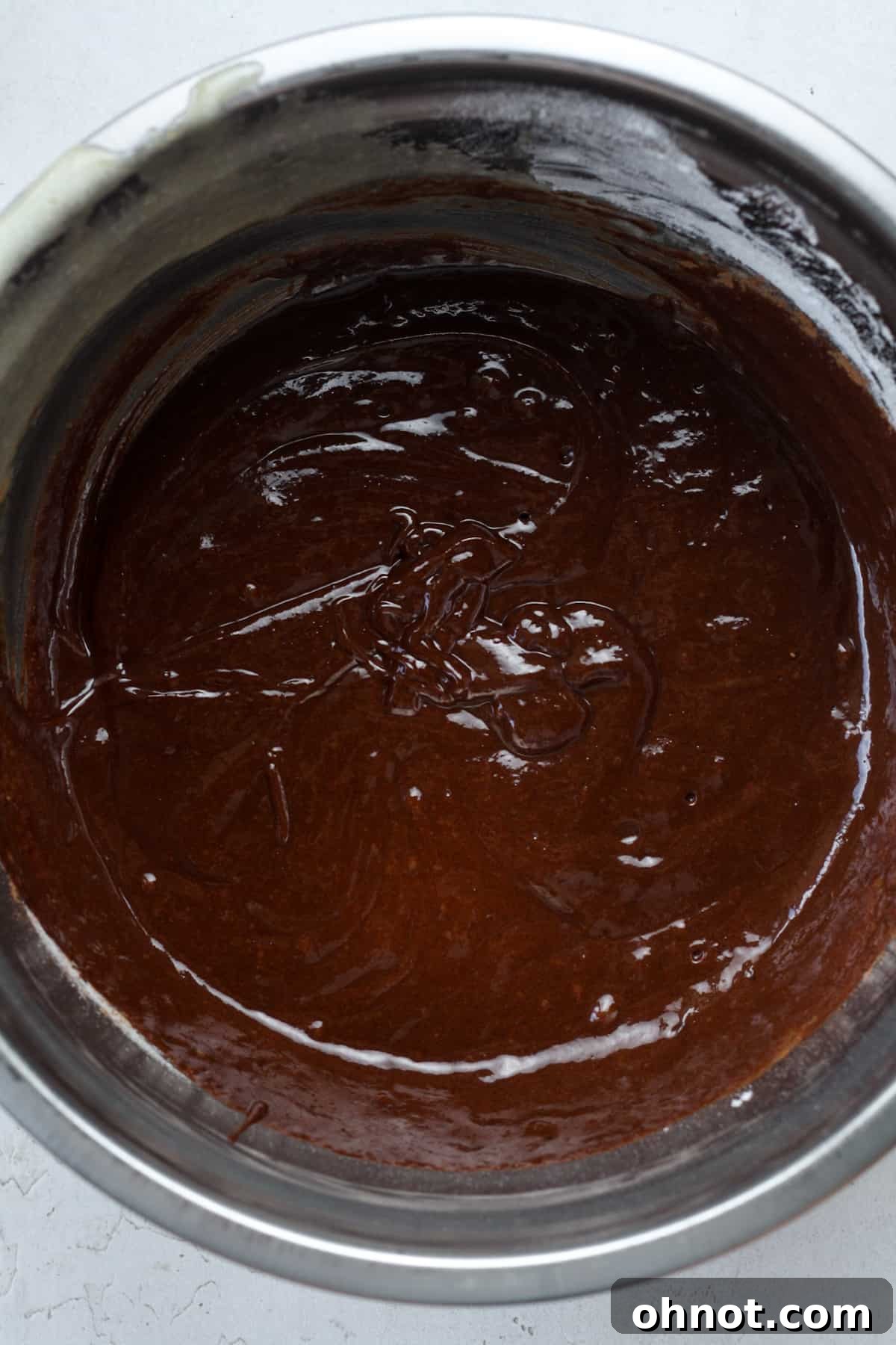 Smooth, dark chocolate brownie batter in a bowl.