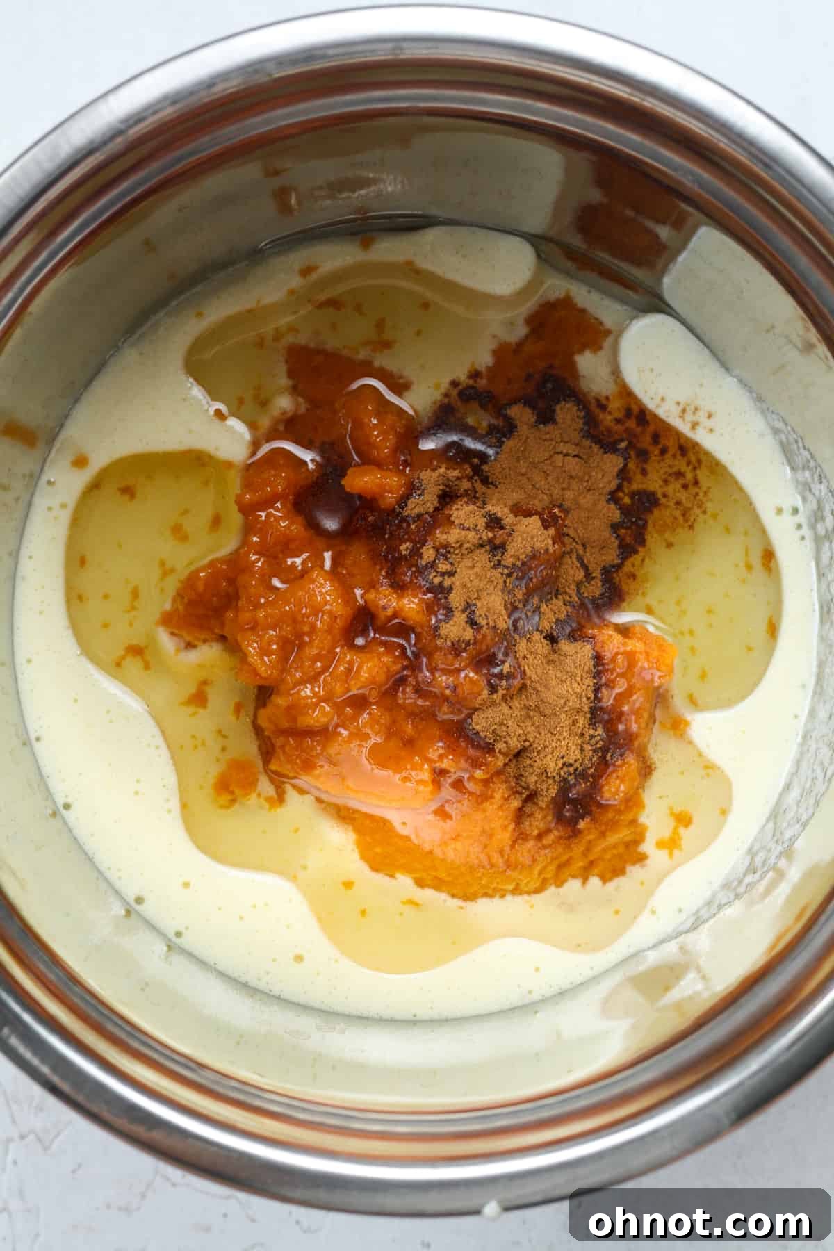 Pumpkin puree, oil, and spice being added to batter.