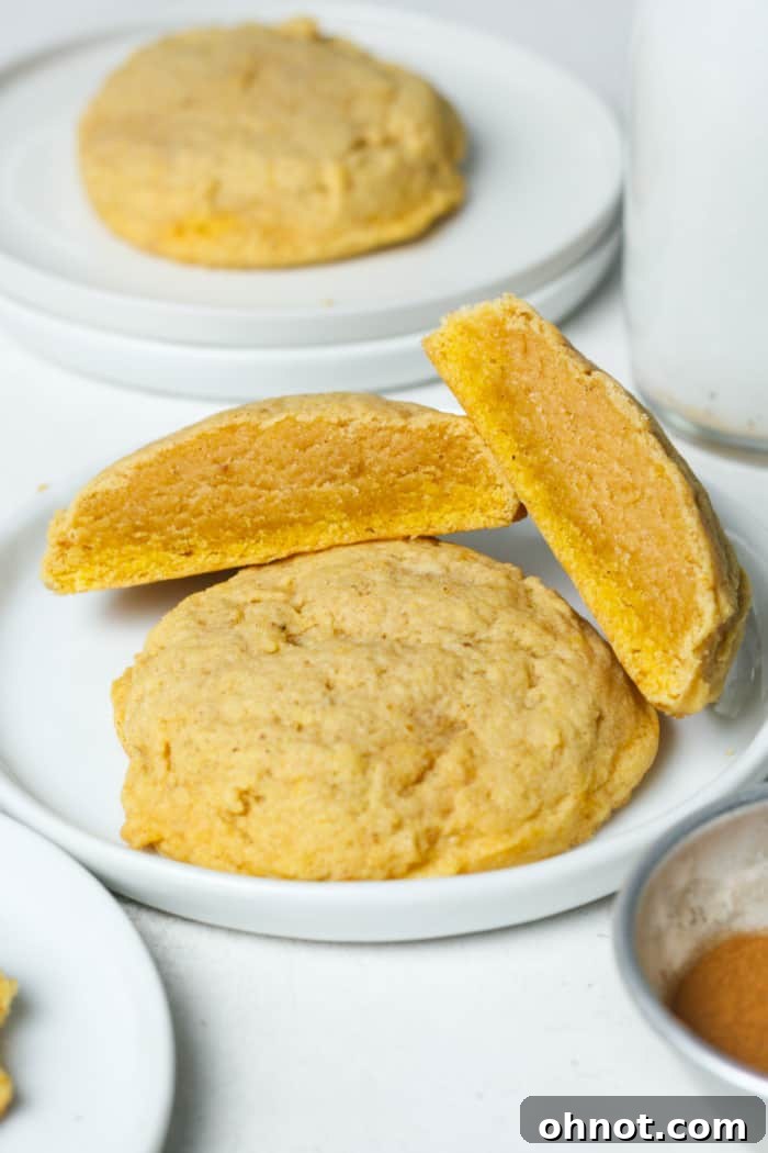 A close-up of a stack of pumpkin spice sugar cookies, highlighting their soft texture.