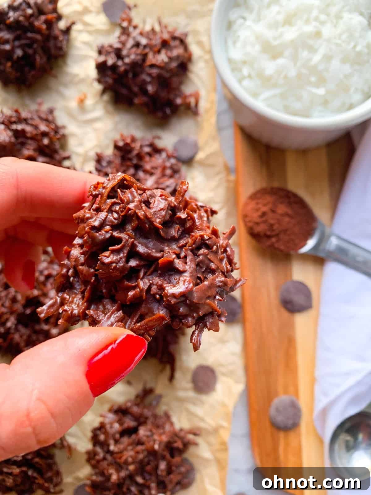 Delicious no-bake chocolate coconut macaroons on a parchment-lined tray, ready to be frozen.