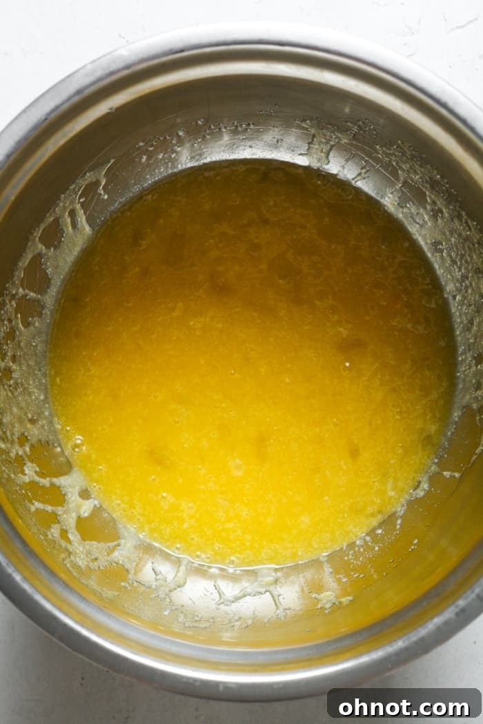 Melted butter, eggs, and sugar mixed in a bowl.
