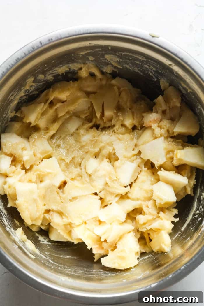 Thick batter with finely chopped apples folded in.