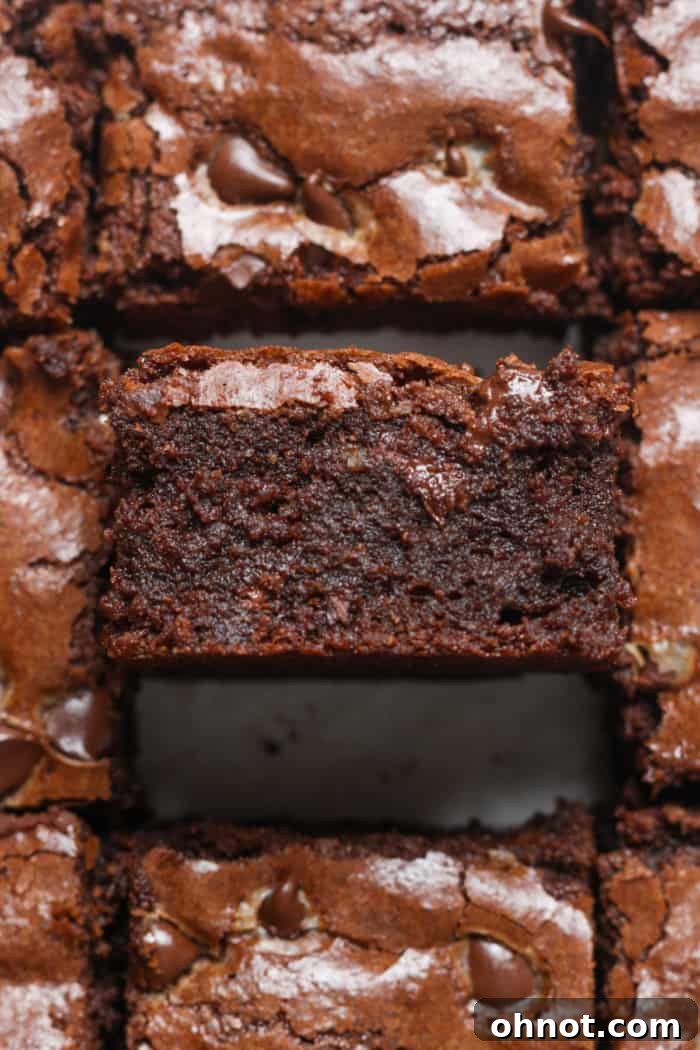 A stack of delicious, gooey almond flour brownies with a rich chocolate center and slightly chewy edges, hinting at their gluten-free and grain-free nature.