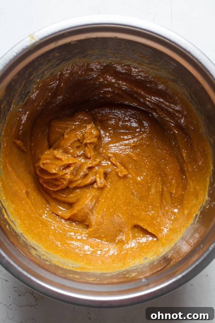 Bowl of peanut butter batter being mixed.
