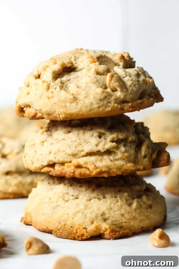A stack of golden brown peanut butter cookies, showing their perfect texture.
