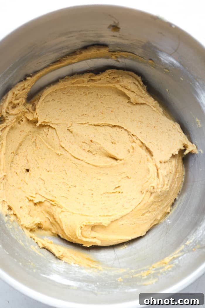Dry ingredients, including flour, cornstarch, and baking soda, mixed into the peanut butter dough.