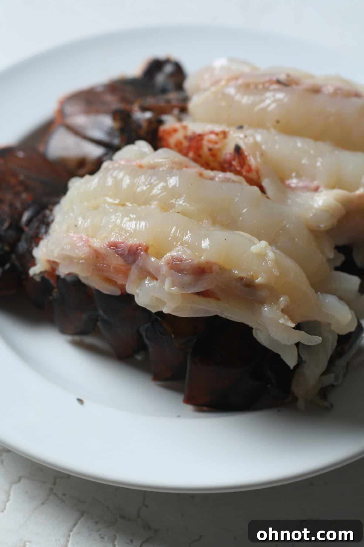 Prepared lobster tails on a white plate