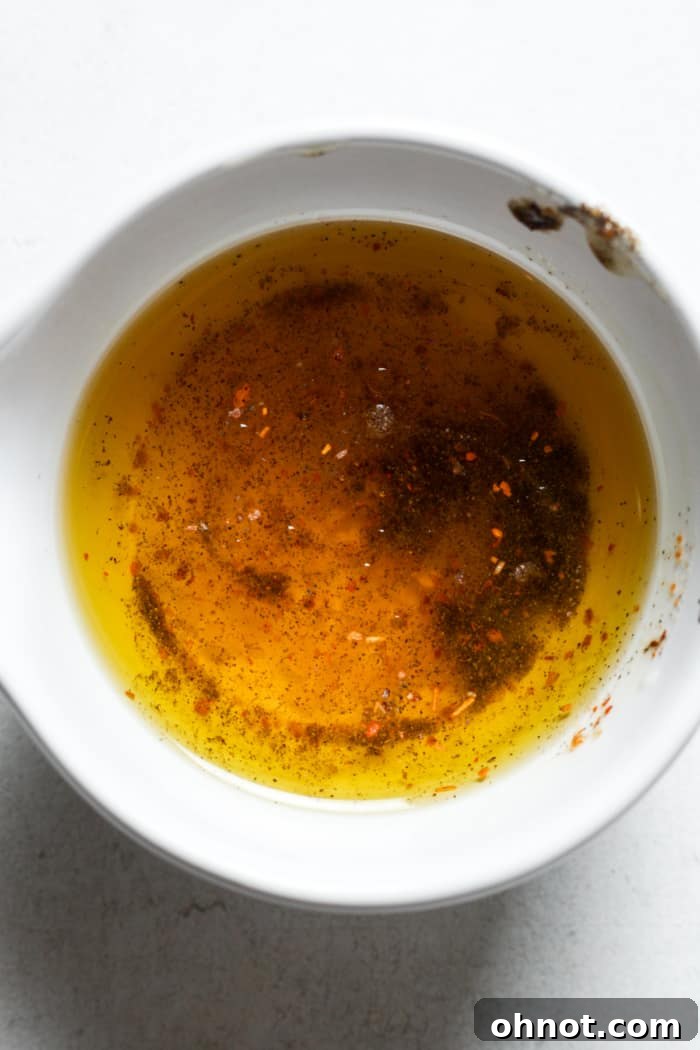 Melted butter, minced garlic, and paprika in a bowl