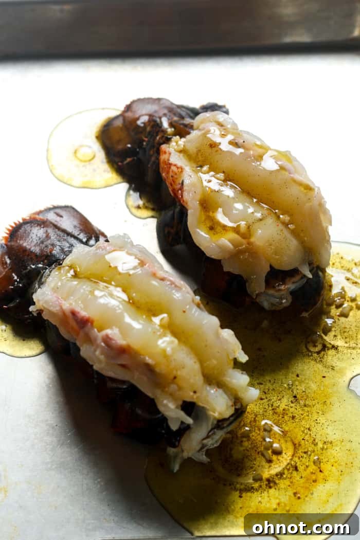 Lobster tails being coated with melted butter mixture