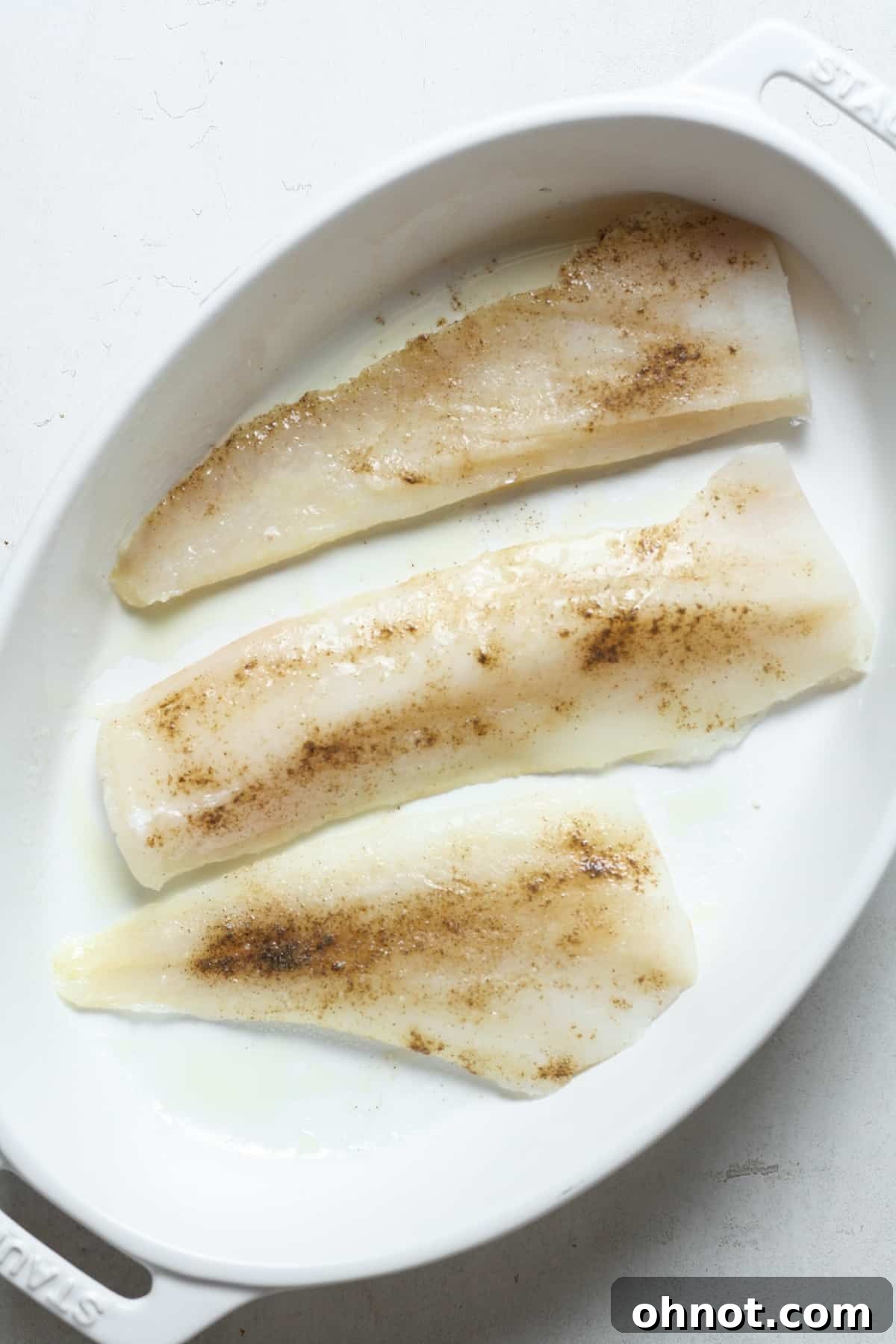 Haddock fillets arranged in a baking pan.