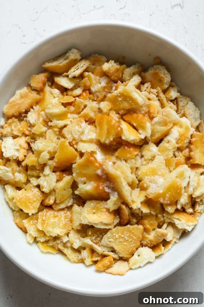 Cracker crumbs mixed with melted butter in a bowl.