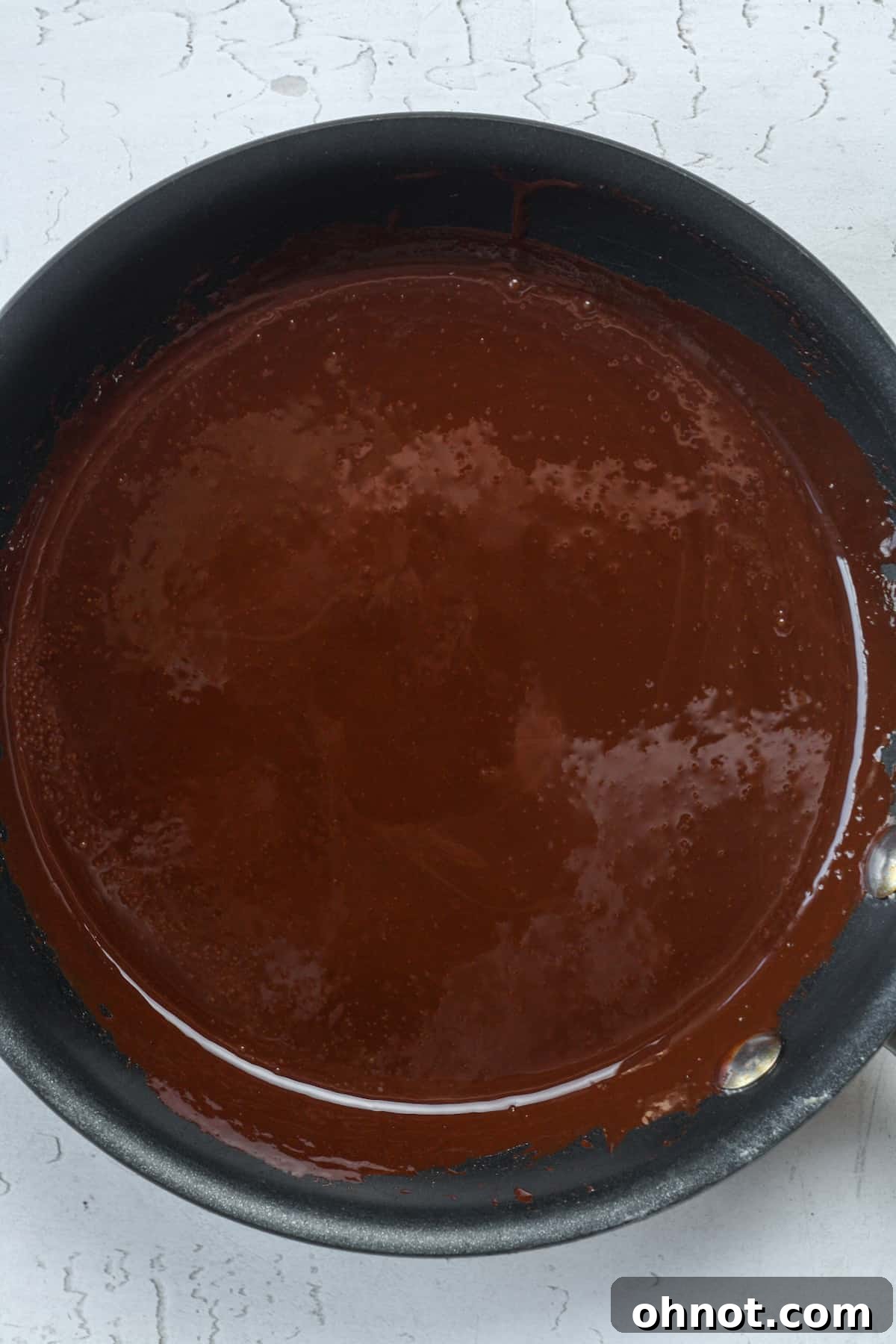 Melted dark chocolate in skillet.