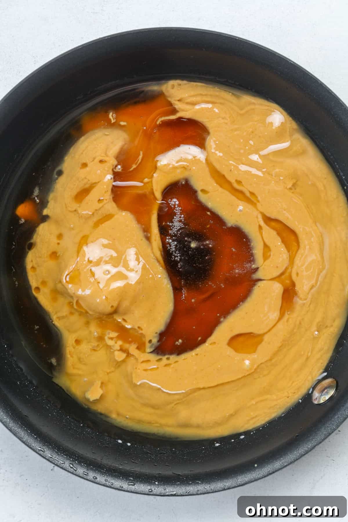 Peanut butter and syrup in skillet.