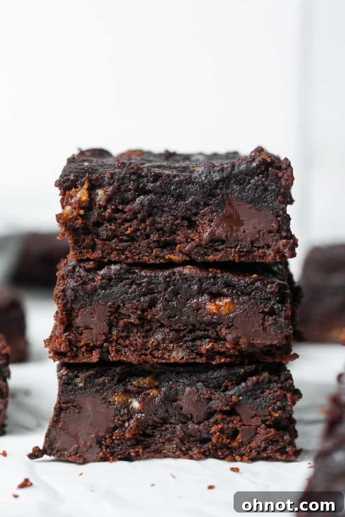 Gooey, rich banana brownies stacked on a cooling rack, showcasing their dark chocolate color and fudgy texture.