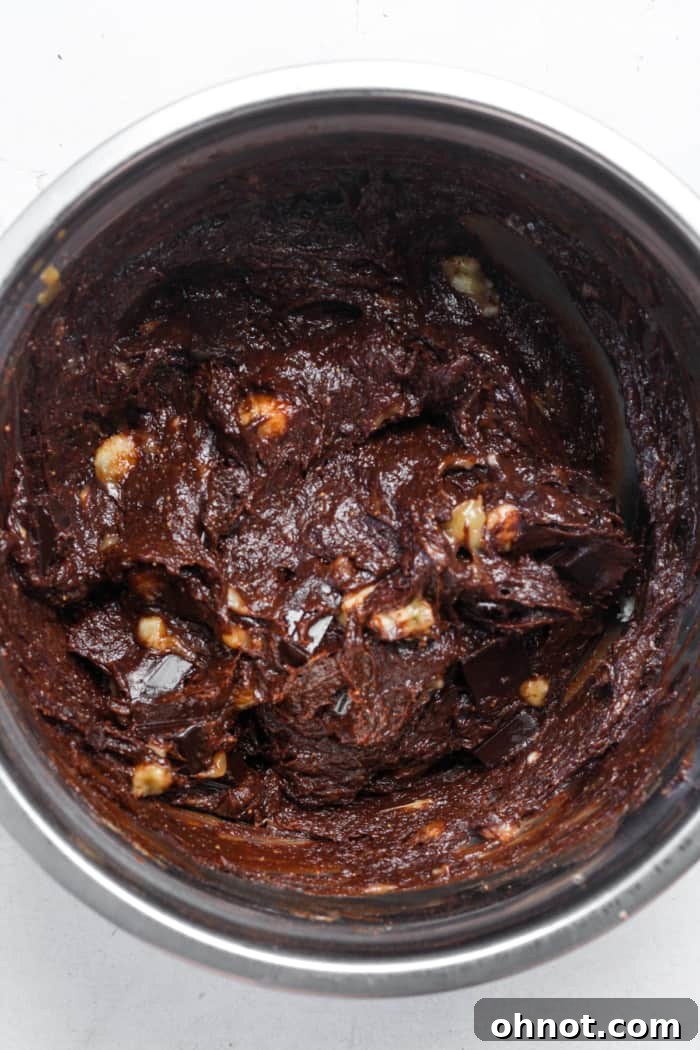 Healthy banana brownie batter with chocolate chips folded in, ready for baking.