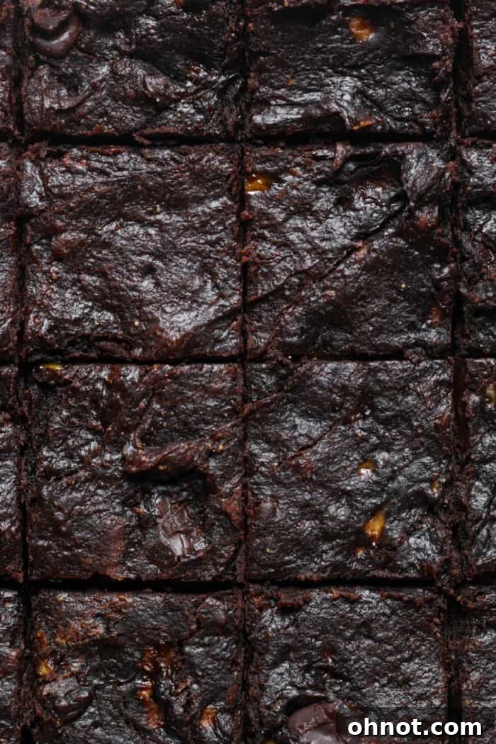 Freshly baked dark chocolate banana brownies, still warm from the oven, showing their perfectly fudgy center.