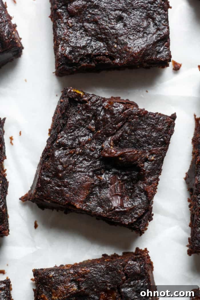 A perfectly sliced square of healthy banana brownie, showcasing its rich, dark color and dense, fudgy interior, with hints of chocolate chips.
