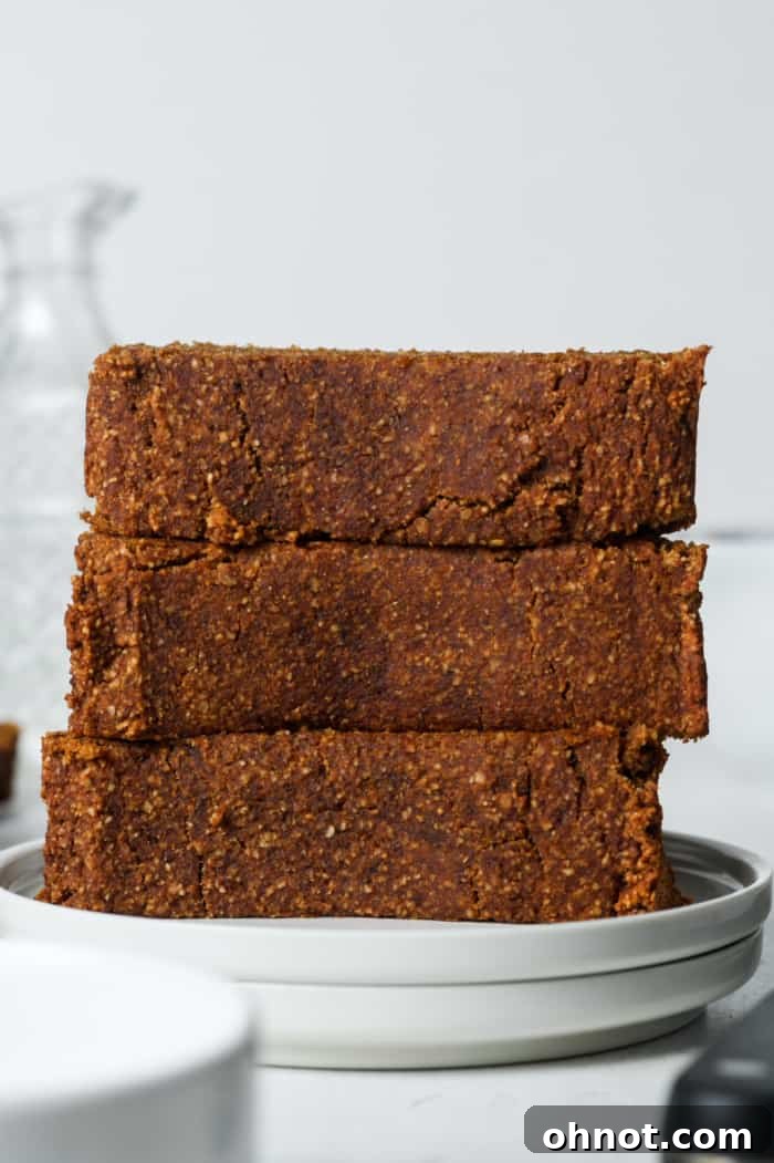 Stacked slices of perfectly baked pumpkin bread, showing moist interior.