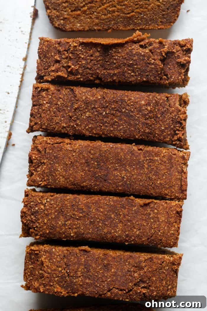 Perfectly cut slices of pumpkin bread on a cutting board.