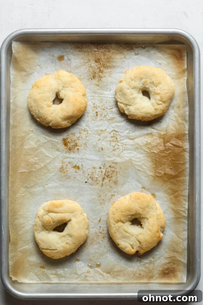 Freshly baked gluten-free bagels, golden brown and hot from the oven.