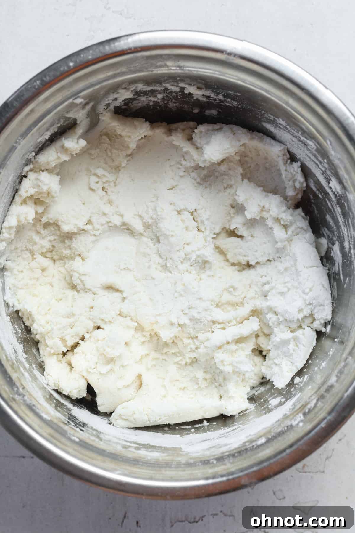 Bagel dough forming in a bowl after mixing.