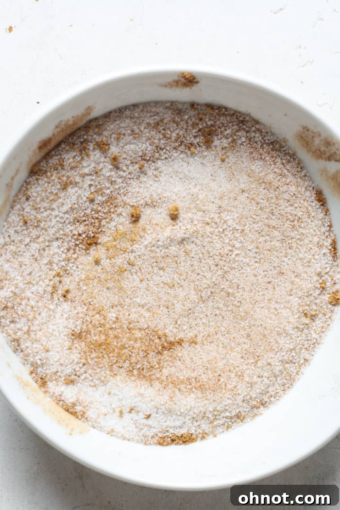 A shallow bowl containing a mixture of sugar and warming chai spices.