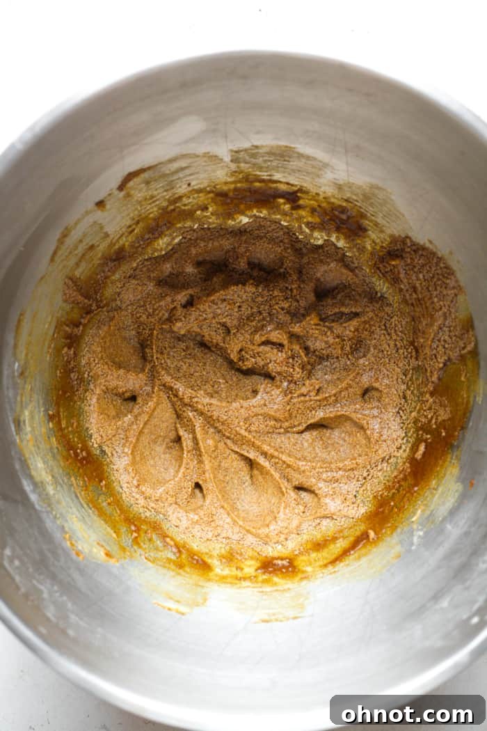 Gooey molasses and butter mixture in a stand mixer bowl.
