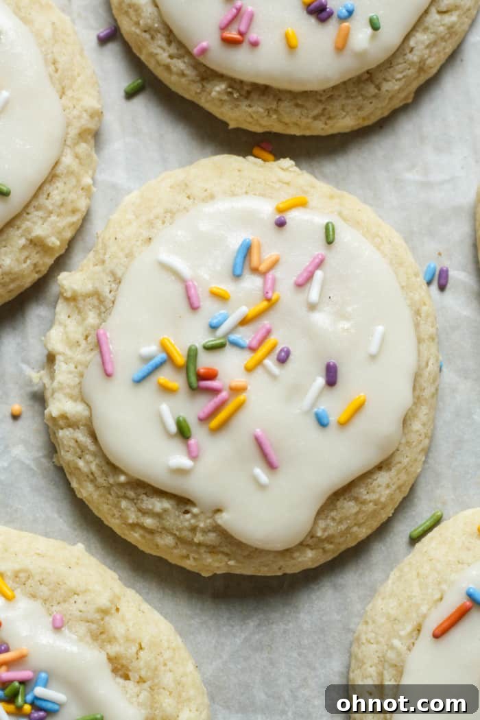 Beautifully frosted sour cream cookies adorned with colorful sprinkles.