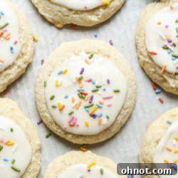 Frosted sour cream cookies on a white plate