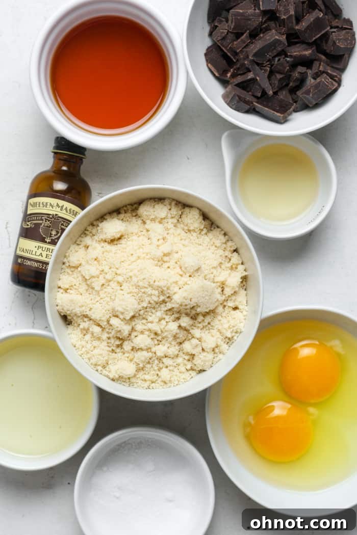 A selection of high-quality ingredients laid out, including blanched almond flour, eggs, and chocolate chips, ready for baking.