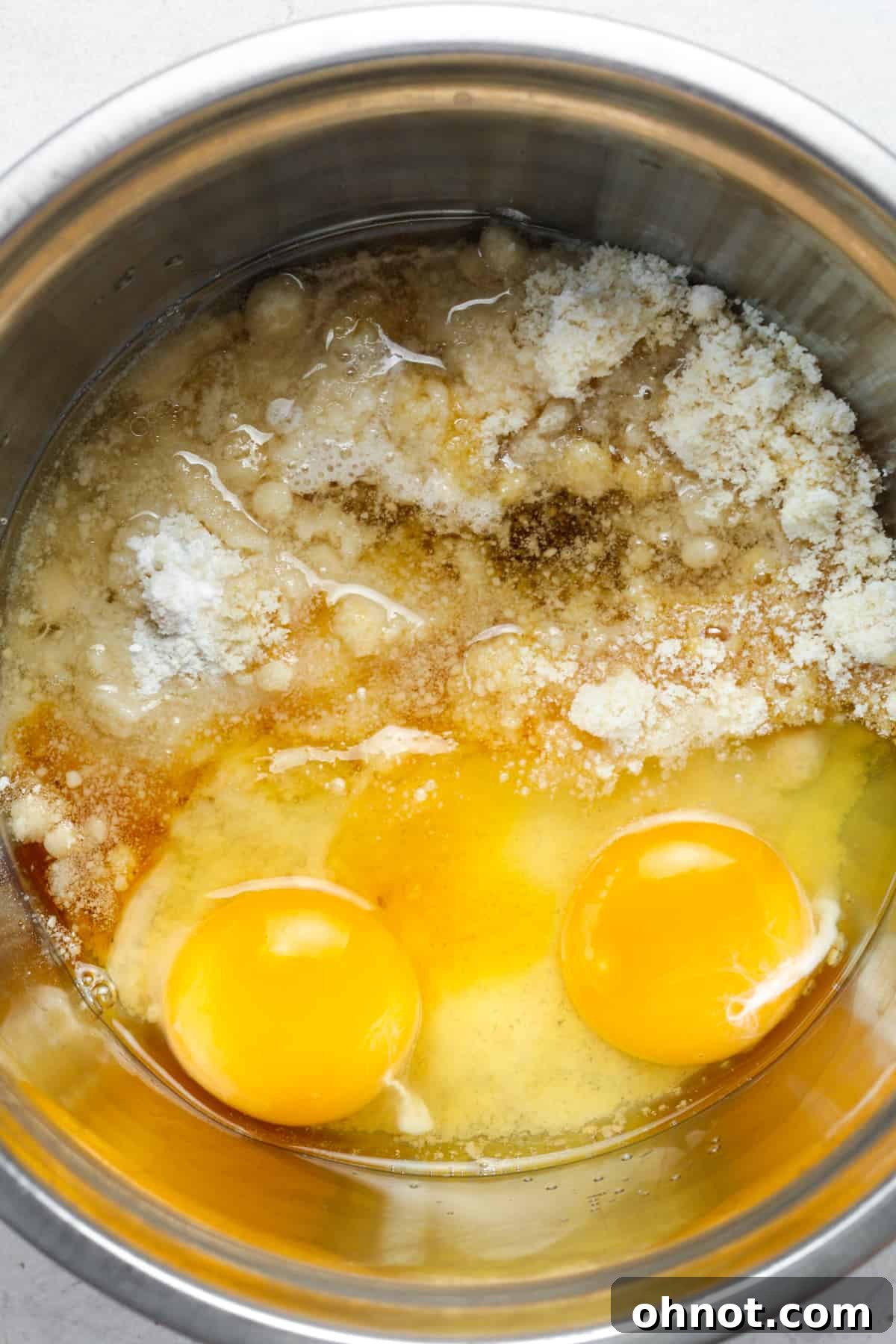 All the muffin ingredients, excluding chocolate chips, are mixed together in a bowl, creating a smooth batter.