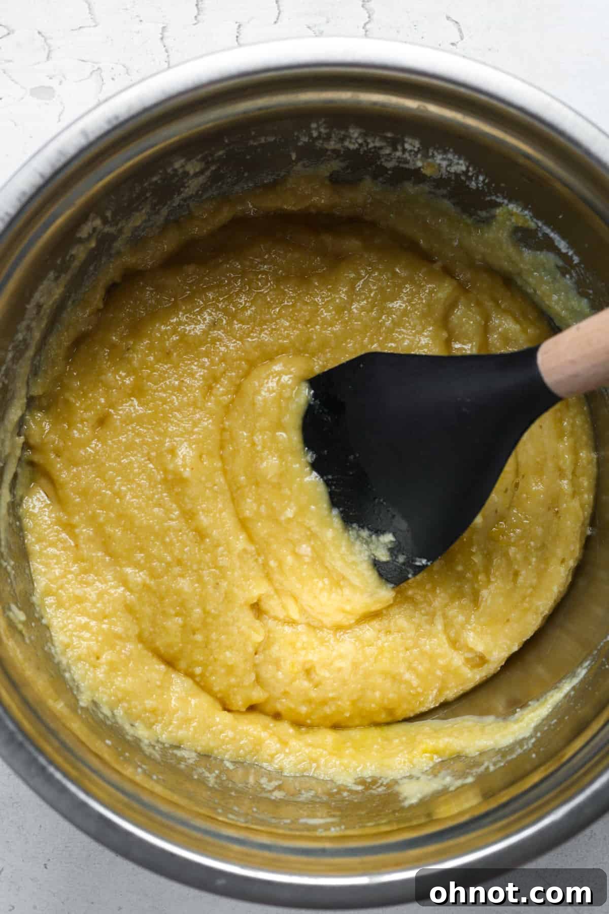 The smoothly combined muffin batter, showcasing its consistent and creamy texture before adding mix-ins.