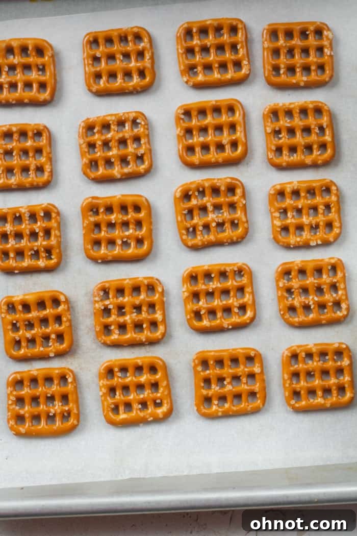 Pretzels neatly arranged on a baking sheet.