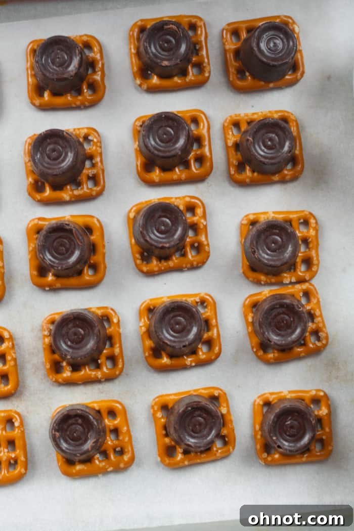 Rolo candies placed on each pretzel.