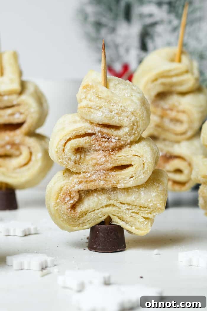 Puff pastry Christmas trees baking in the oven, showing a beautiful golden rise.