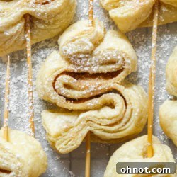 Festive puff pastry Christmas trees, golden and dusted with sugar.