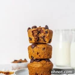 A stack of three Flourless Paleo Pumpkin Muffins on white plates.