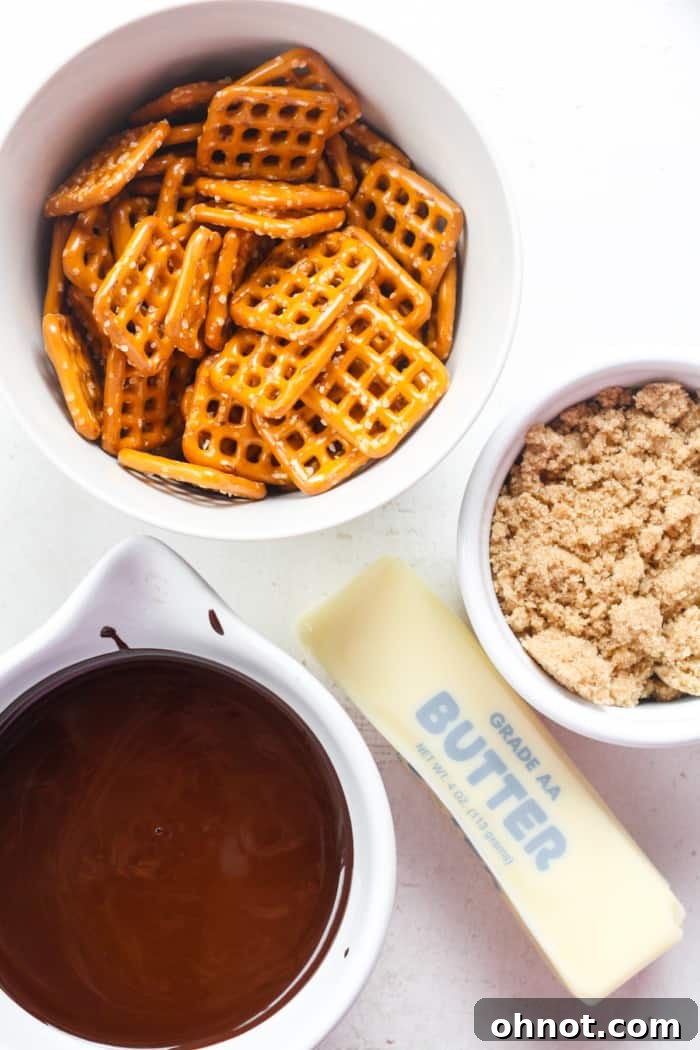 Close-up of pretzels, chocolate chips, and butter, the main ingredients for pretzel crack.