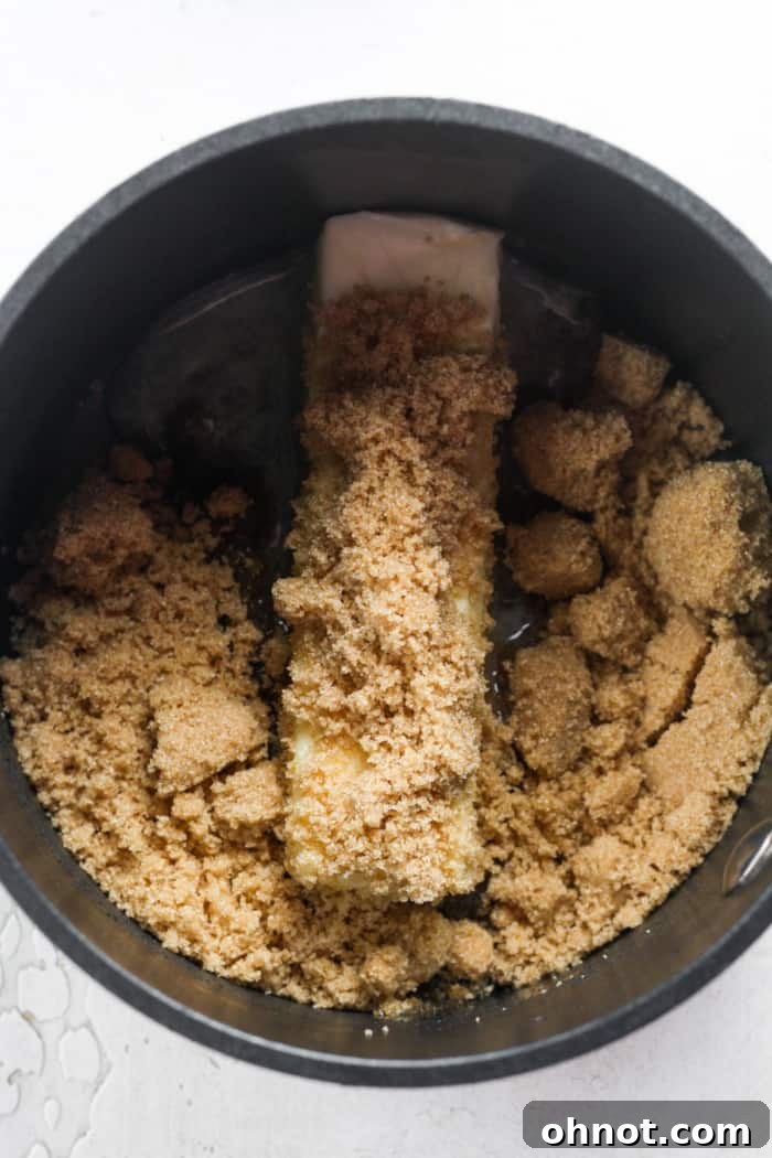 Unsalted butter and light brown sugar in a saucepan, ready to be melted for the caramel.