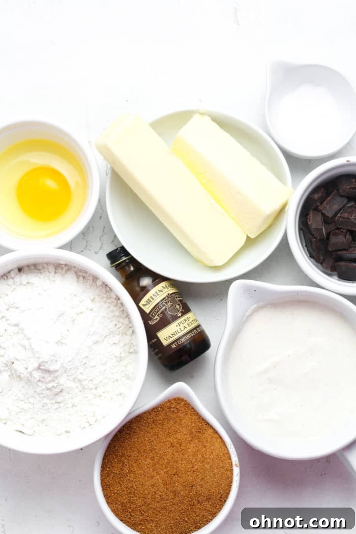Ingredients for sourdough chocolate chip cookies, including butter, sugar, egg, flour, and chocolate.