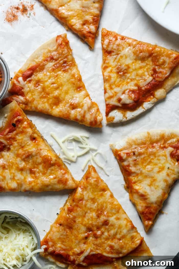 A freshly baked sourdough pizza, cut into slices, showing a thick, inviting crust.